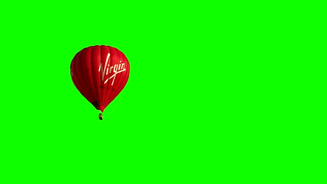 Red balloon floating on green background