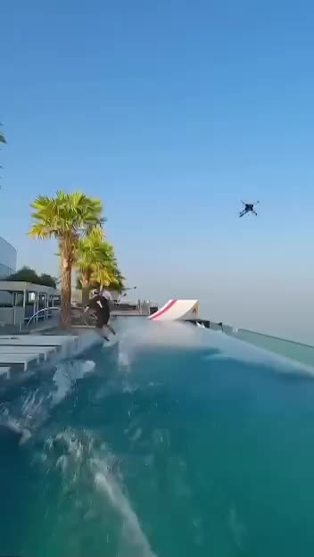 Amazing! Man Surfs Waterway On Top Of Skyscraper & Then Does This!