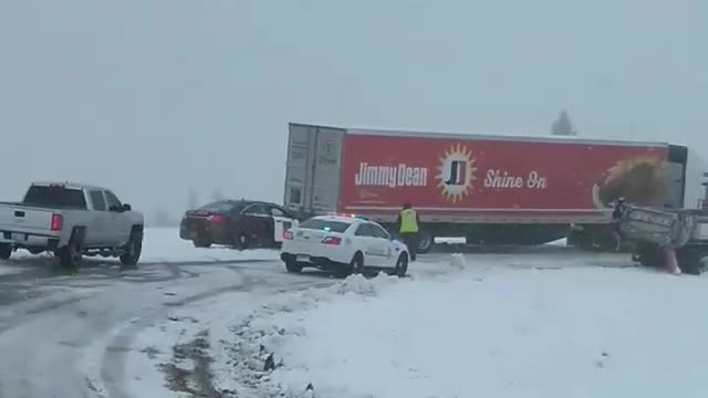 State Trooper Pushes Semi Stuck in Snow