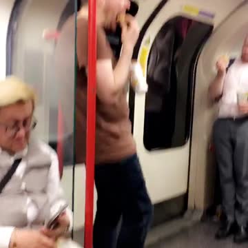 Guy eats fast food on subway