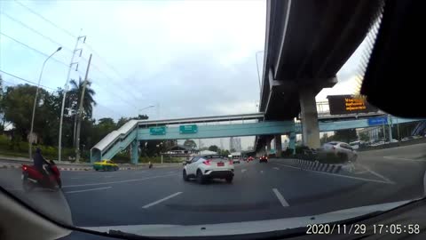 Vehicle Swerves into Car and Forces it onto Barricade