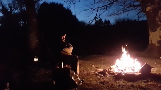 Talking by campfire.