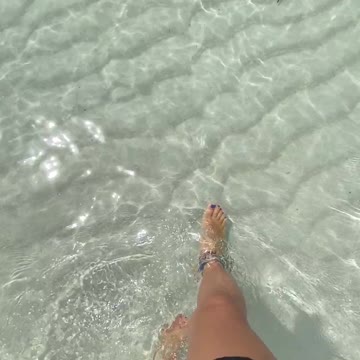 Woman Walking On White Sand Of Sea Water