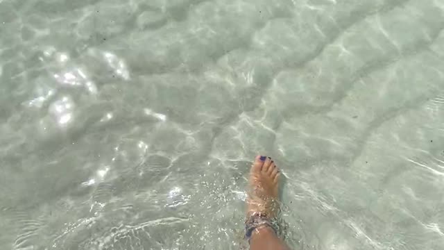 Woman Walking On White Sand Of Sea Water