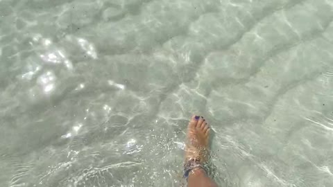 Woman Walking On White Sand Of Sea Water