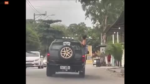 Brazilian Girl Picked A Bad Time To Climb On Top Of The SUV