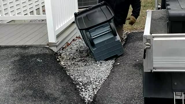 Determined Man Goes To War With Garbage Can During Wind Storm