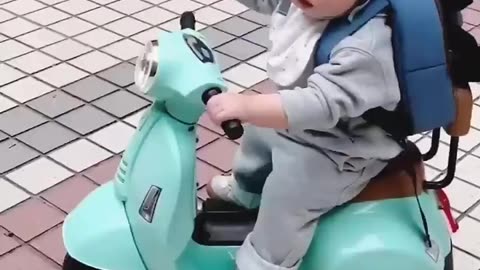 Toddler boy going to school with scooty