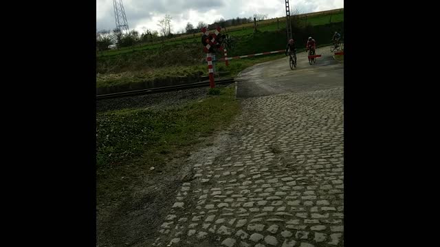 Another extremely near miss at a train crossing in the Tour of Flanders bike race.