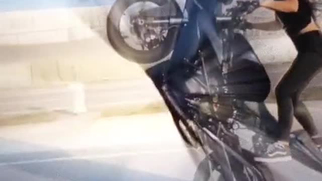 Beautiful girl stunt a bike