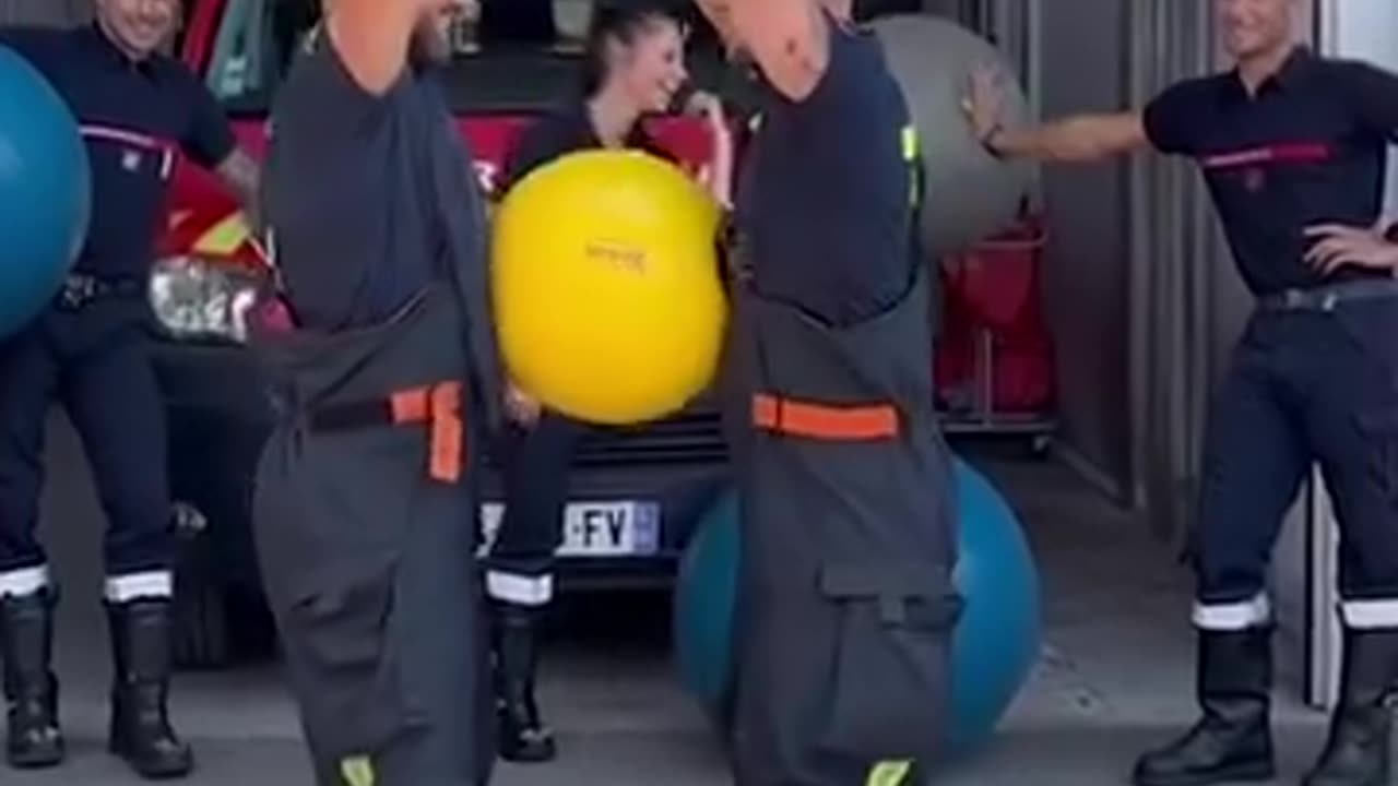 Synchronized firefighter yoga ball challenge