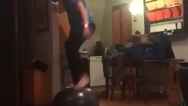 Guy blue shirt on top of ball falls down