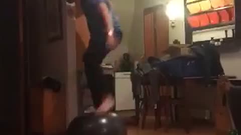 Guy blue shirt on top of ball falls down