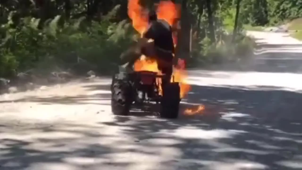 atv catches fire with guy riding it