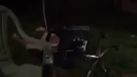 Man in grey jacket rolls back in office chair and dabs while falling down