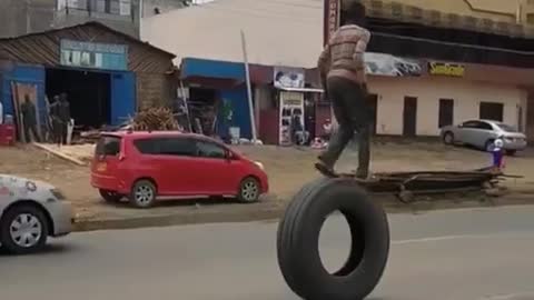 little boy fun riding on big tyre