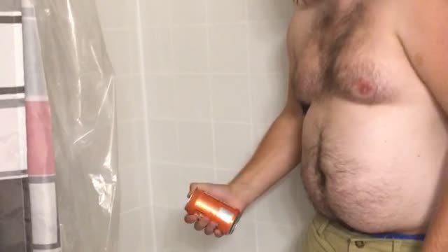 Fat guy in tub with green shorts cant smash red beer can