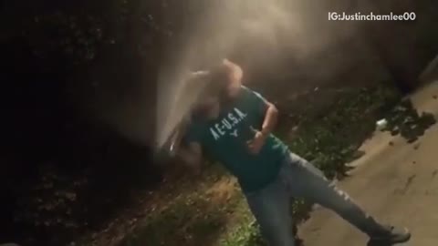 Guy in green shirt cracks beer open with his head