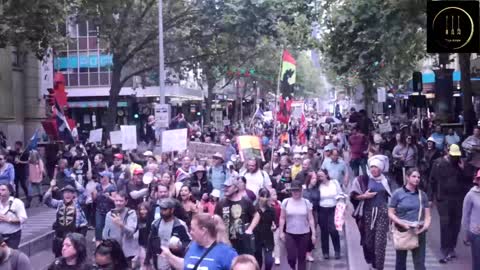 Parents march for their children among uniquely-masked onlookers.