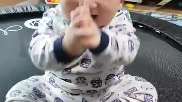 This is a video of a baby enjoying clapping and having fun.