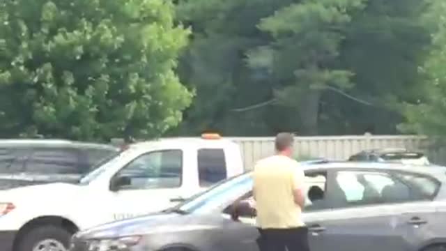 Man in yellow shirt black wet suit half on