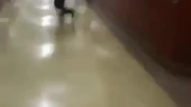 Guy in gray hoodie runs into lockers and falls down