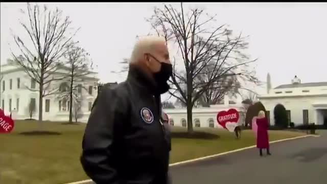 US President Biden gives a cup of coffee to the Al Jazeera English correspondent