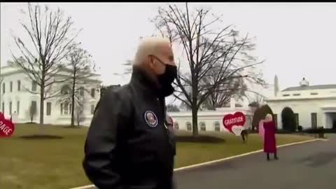 US President Biden gives a cup of coffee to the Al Jazeera English correspondent