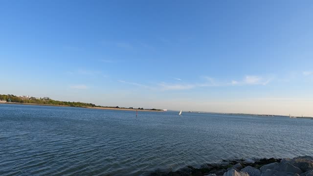 Boat coming from the sea to a mouth of a river.