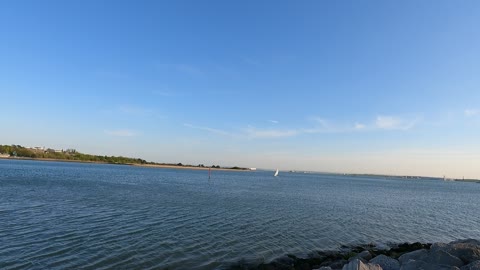 Boat coming from the sea to a mouth of a river.