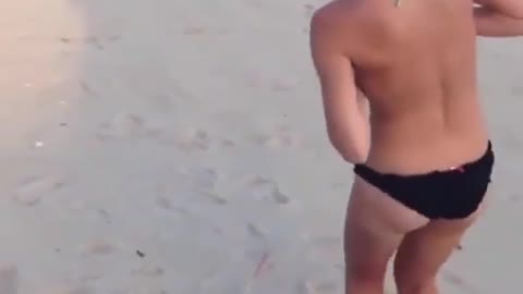 dog tries to take off her bikini