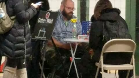 Man and woman playing connect 4 at station