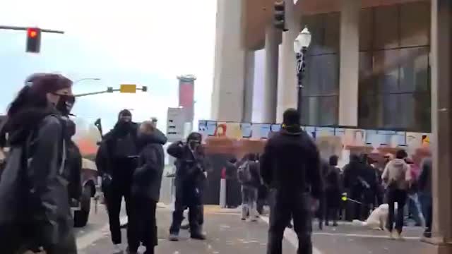 Blm surrounding a group of back the blue supporters.