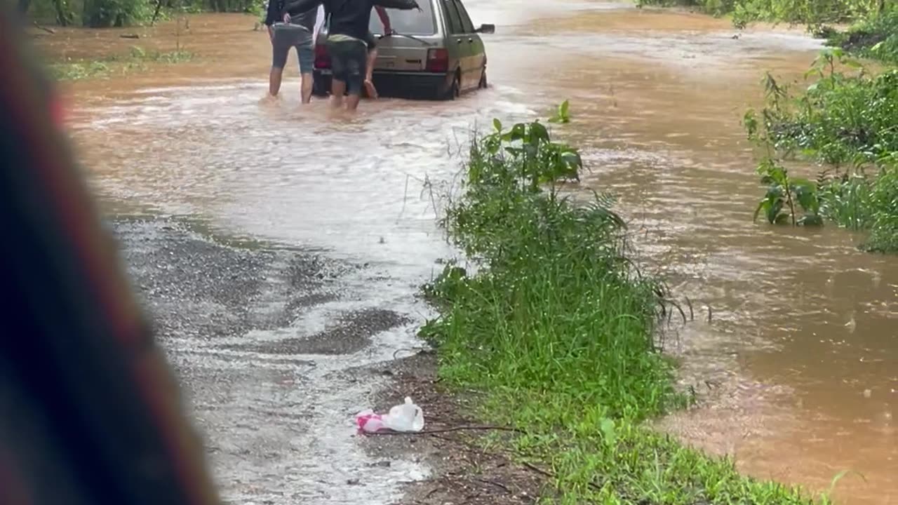 Men Push Car Through Flooded Street