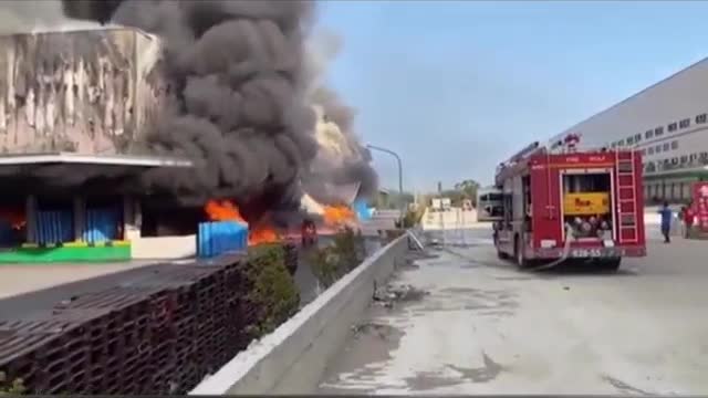 Fire at Carrefour Logistics Center in Taoyuan, Taiwan, smoke billows into the sky