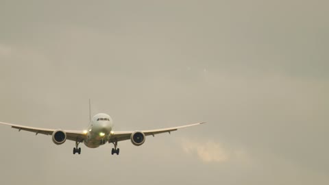 Airplane flying in a gray sky