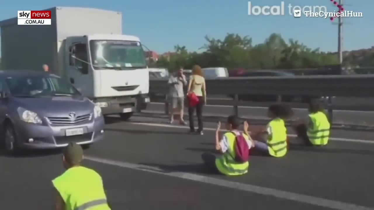 Furious drivers physically drag activists off a busy highway