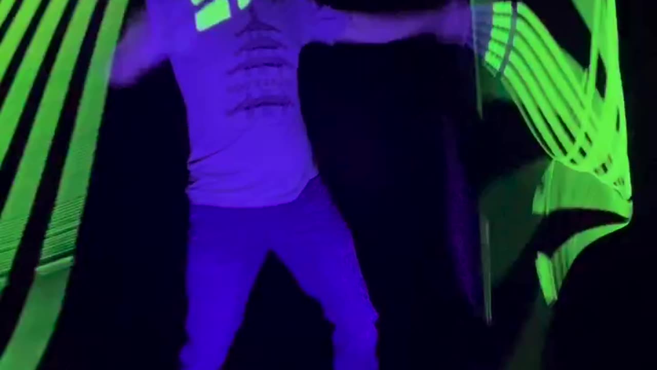 Man Practices With Glow in the Dark Whips At Night