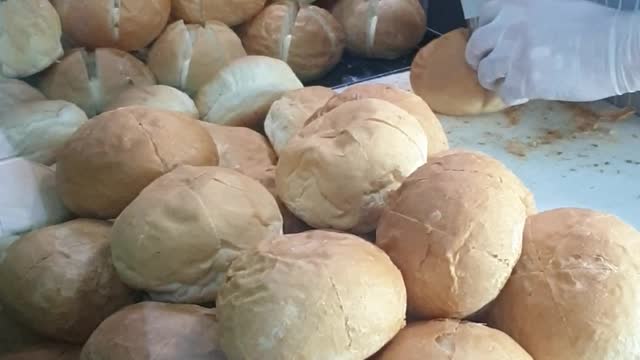 She is putting cheese cream in garlic cheese cream bread.