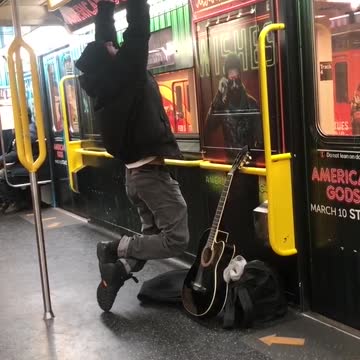 Man does pull ups on subway train