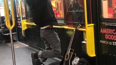 Man does pull ups on subway train