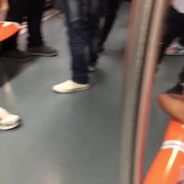 Two men asleep on orange seats subway train