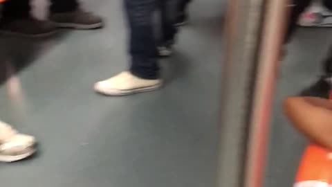 Two men asleep on orange seats subway train