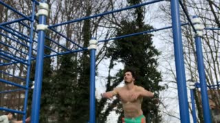 Guy does gymnastics flip on park jungle gym and falls off