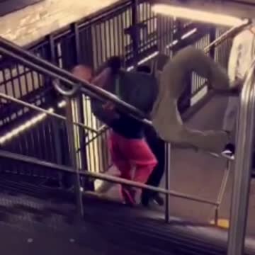 Three guys walking up stairs roll back down subway