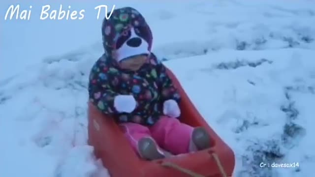 Dog and baby together in the snow and beautiful laughter