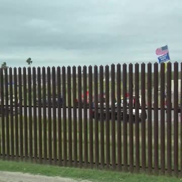 Biden Driving Through Gate In Calm Part Of Border Wall, Pro-Trump Protesters Gathered On Other Side