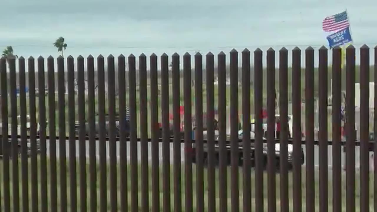 Biden Driving Through Gate In Calm Part Of Border Wall, Pro-Trump Protesters Gathered On Other Side