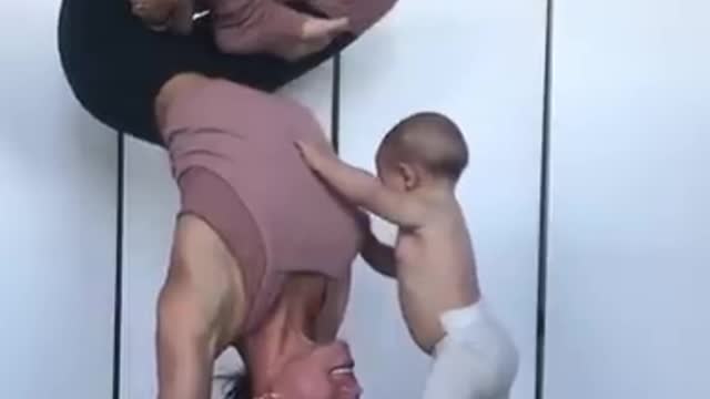 Baby Climbs On Mom Performing Yoga Pose 🥰