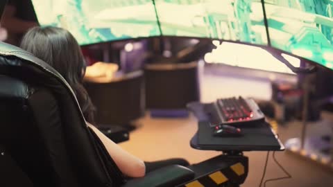 A Woman Sitting In A Gaming Chair Set-up